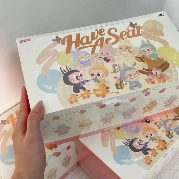 Children's step stool with cartoon characters and 'Have a Seat' text on a light background